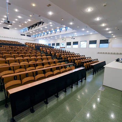 lecture theatre with wooden desks and chairs