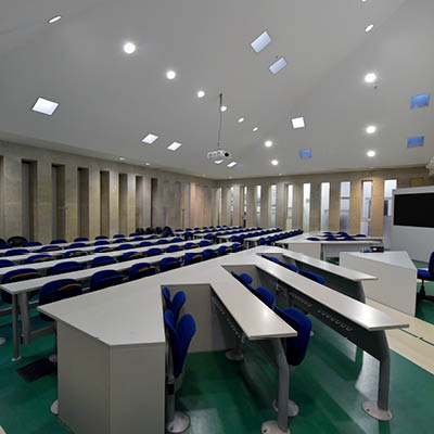 rows of white desks and blue chairs