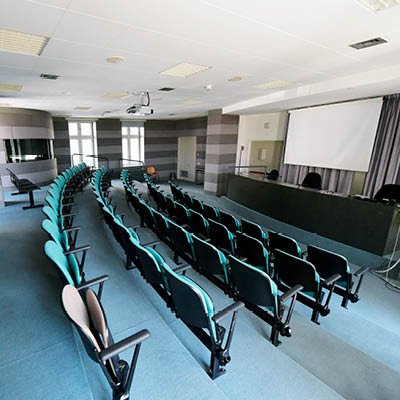 large lecture theatre with rows of fixed chairs