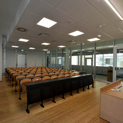 lecture room with rows of desks and fixed chairs